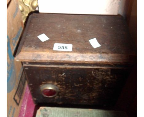 A vintage oak cased A/C voltage transformer with leather carrying strap and red bull's-eye light