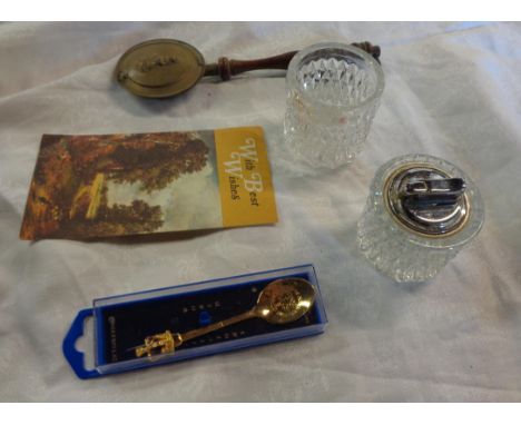 A bag containing a quantity of collectable items including Colibri moulded glass table lighter and similar base, commemorativ