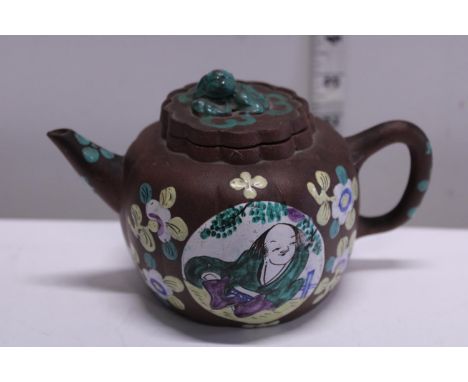 A vintage Chinese terracotta teapot with character marks to base and applied enamel decoration 
