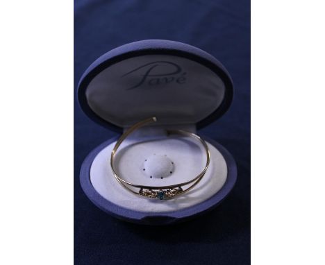 A 9ct gold bangle set with blue topaz 3.47g 