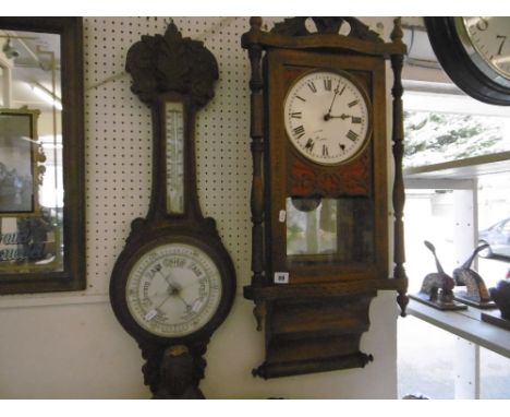INLAID WALL HANGING CLOCK PLUS A CARVED OAK BAROMETER, SOME DAMAGE