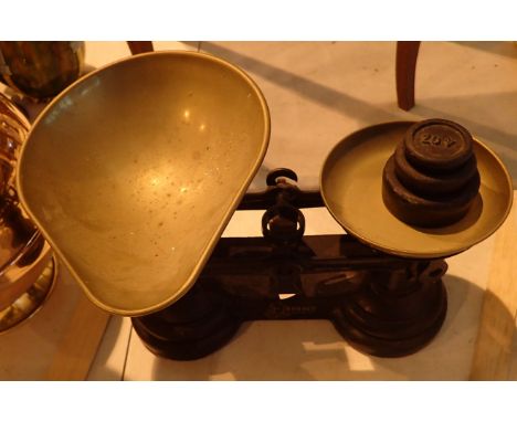 Pair of metal balance scales with brass pans and steel weights 