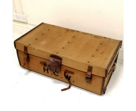 Vintage canvas with leather mounted trunk, bears the initials H C W with original key and makers plate A E Rickards Trunk mak