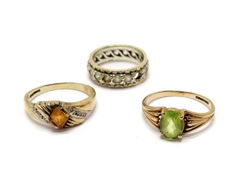 3 x 9ct hallmarked gold rings - peridot, orange stone with diamond set shoulders (size O), white stone eternity ring (missing