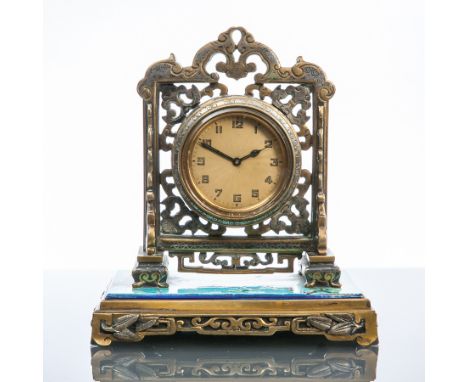 EARLY TWENTIETH CENTURY CHINESE STYLE BRASS DESK CLOCK
unsigned keyless wind movement, the gilt guilloche dial with stylised 