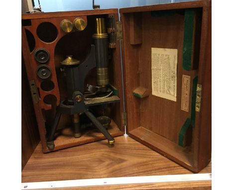 BRASS MONOCULAR MICROSCOPE BY J.SWIFT & SON, LONDON early twentieth century, lacquered brass and ebonised finish, the base si