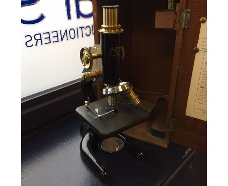 CASED BRASS MONOCULAR MICROSCOPE BY CHARLES PERRY, LONDON
early twentieth century, lacquered brass and ebonised finish, the t
