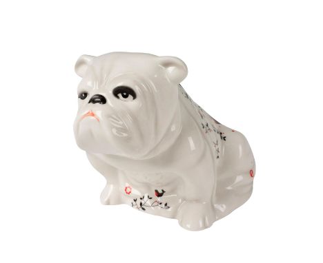 Modeled as a white seated bulldog decorated with images synonymous with London. From the London eye to the London bus. Royal 
