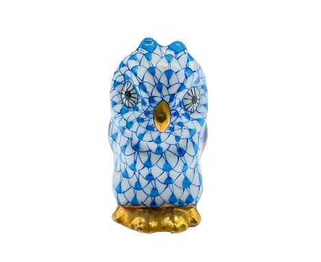 Colorful hand-painted figure of a resting owl in the classic blue fishnet scale pattern with green/pink/blue wings and gold a