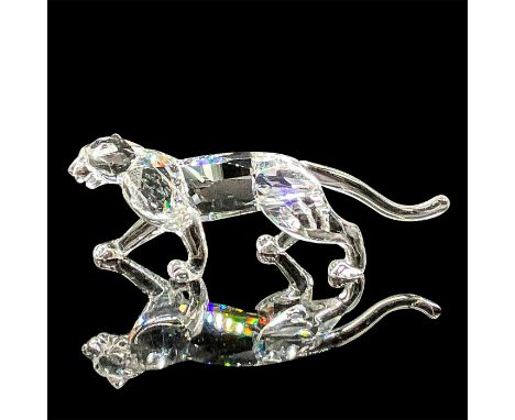 A clear figure of a wild cat with tawny-color eyes. Swarovski mark. This item has its original box: 5"W x 8.5"H. Artist: Mich