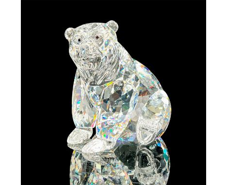 A clear faceted seated bear with black eyes. Swarovski mark. This item has its original box: 6"W x 4.75"H. Artist: Heinz Tabe