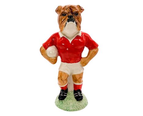 Limited edition hand decorated ceramic figure featuring a standing American bulldog soccer player with a soccer ball in arms.