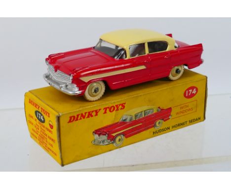 Dinky - A boxed Hudson Hornet sedan in cream over red # 174. The car appears in Very Good to Near Mint condition with origina