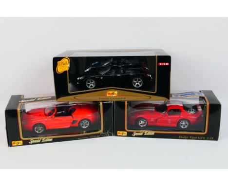 Maisto - Three boxed diecast 1:18 scale model cars from Maisto. Lot consists of Maisto 'Premiere Edition' Porsche Carrera GT;