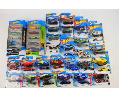 Hot Wheels - A collection of 25 carded Hot Wheels with two 5-Car Packs. Lot includes Aston Martin Vulcan (HW Exotics); Kool K