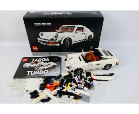 Lego - A boxed 2021 Lego #10295 Porsche 911. The model is partially constructed, and shows dusty signs of display. The model 