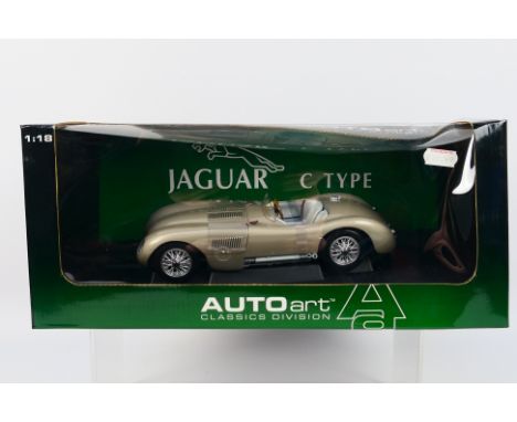 Auto Art - A boxed 1:18 scale Auto Art #73502 Jaguar C-Type 1951. The model in bronze appears to be in Mint condition housed 