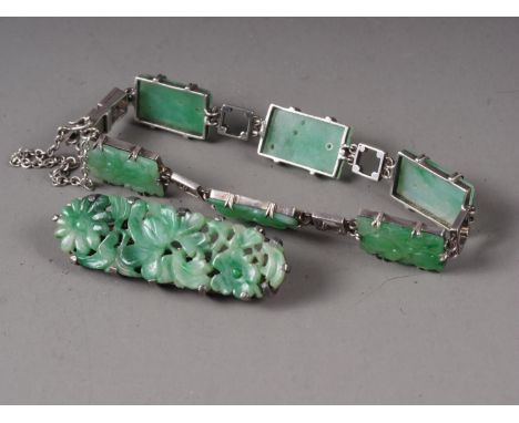 A Chinese floral carved green jade and white metal mounted brooch and a similar braceletCondition:Brooch: A small split to ri