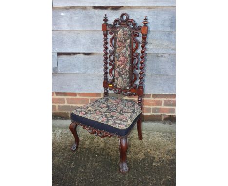 A 19th century carved rosewood framed low seat nursing chair with tapestry panel back and seat, on cabriole supports 