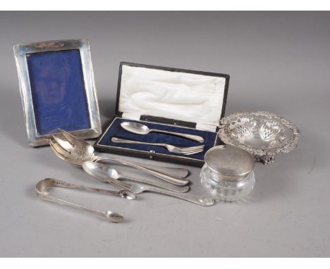 A silver fork and spoon christening set, a similar fork and spoon, a silver topped toilet jar, a pierced bonbon dish, a pair 
