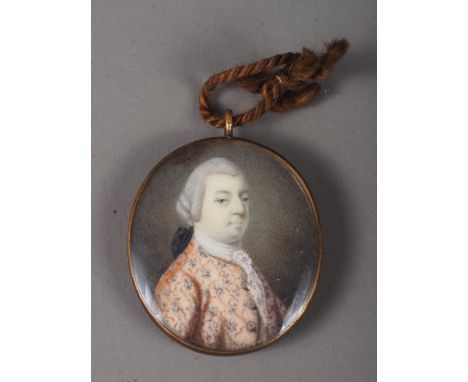 An 18th century portrait miniature of an unknown gentleman, in embroidered jacket, 3.8cm x 3.2cm, in gilt frame 