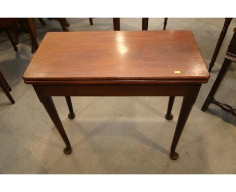 A Georgian mahogany fold-over top card table, on pole turned supports and pad feet, 32" wide x 16" deep x 28" high 