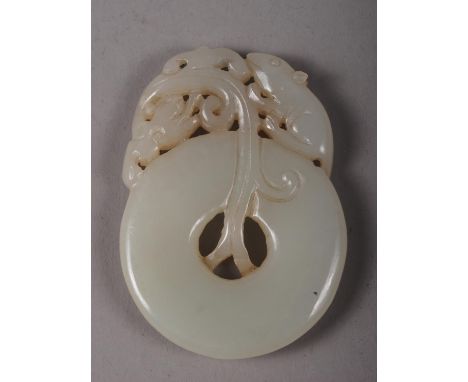 A Chinese carved jade Pi disc with rat and dragon decoration, 2" high 