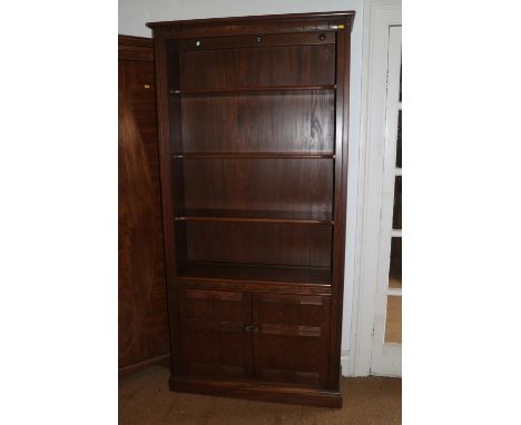 An Ercol elm bookcase, fitted two doors, on block base, 38" wide x 14" deep x 77" high, and a similar Ercol elm open bookcase