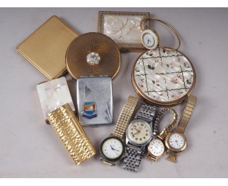A 1960s Dunhill rolled gold cased cigarette lighter, a carved mother-of-pearl cased compact, three other compacts and five wr