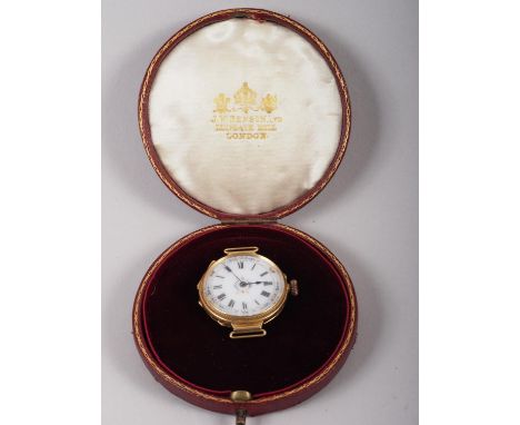 An 18ct yellow gold "trench style" watch with decorated cisele case and ceramic dial, 13.6g approx, in Benson case 