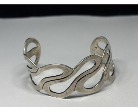 A MARKED SILVER BANGLE