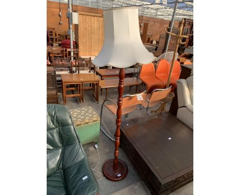 A TURNED COLUMN STANDARD LAMP WITH SHADE