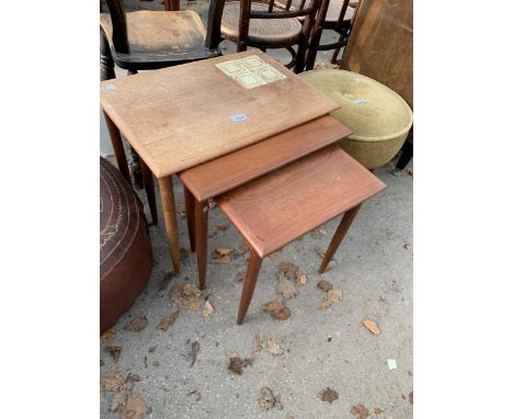 A RETRO TEAK NEST OF THREE TABLES WITH PARTIAL INSET TILE TOP