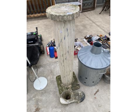 A DECORATIVE CONCRETE COLUMN PEDESTAL AND A BOOT PLANTER