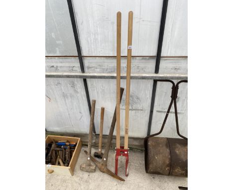 AN ASSORTMENT OF TOOLS TO INCLUDE POST HOLE DIGGERS, A PICK AXE AND TWO SLEDGE HAMMERS ETC