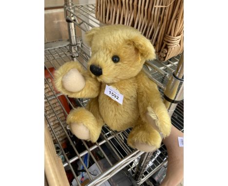 A VINTAGE STEIFF TEDDY BEAR WITH EAR BUTTON LABEL