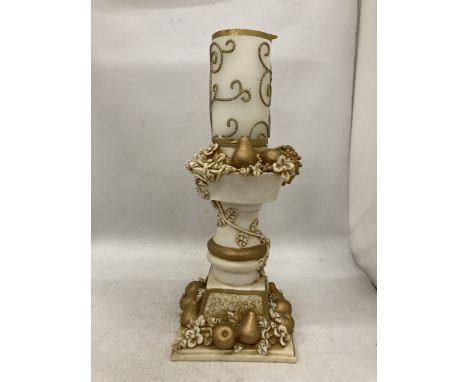 AN ORNATELY DECORATED CANDLE STICK HOLDER WITH FRUIT AND FLOWER DECORATIONS TOGETHER WITH CANDLE, HEIGHT OF HOLDER 28CM