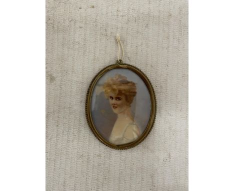 A VINTAGE HAND PAINTED MINIATURE PORTRAIT IN A YELLOW METAL FRAME