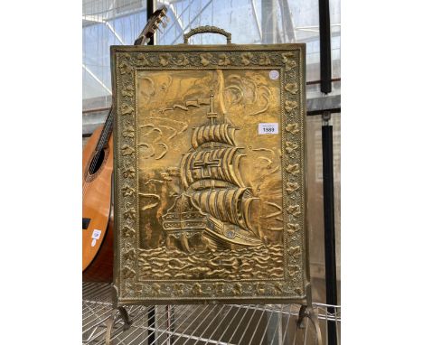 A DECORATIVE BRASS FIRE SCREEN DEPICTING A SHIP
