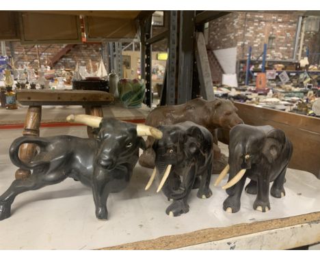 A QUANTITY OF ANIMAL FIGURES TO INCLUDE TWO WOODEN ELEPHANTS, A LARGE CERAMIC BULL - A/F TO LEG,  A LARGE CANDLE IN THE SHAPE