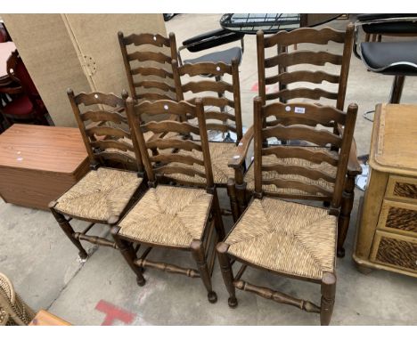 A SET OF SIX LANCASHIRE STYLE LADDER BACK DINING CHAIRS WITH RUSH SEATS, TWO BEING CARVERS