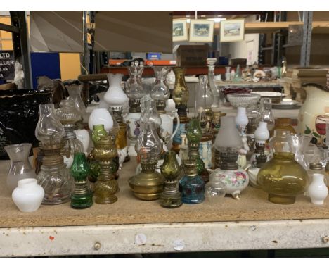 A LARGE COLLECTION OF SMALL CERAMIC AND GLASS OIL LAMPS