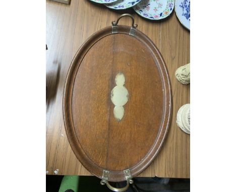 A VINTAGE OVAL OAK TRAY WITH BRASS DECORATION, ON BUN FEET, 59CM X 42CM