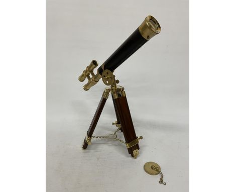 A WOOD AND BRASS TELESCOPE WITH SIGHTS AND TRIPOD LEGS