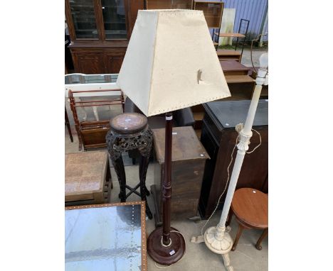 A STANDARD LAMP WITH SHADE