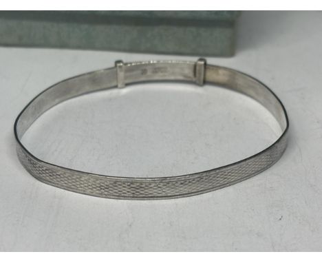 A MARKED SILVER BANGLE IN A PRESENTATION BOX