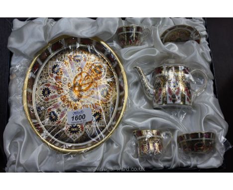 A Royal Crown Derby Imari style miniature Teaset including tray, teapot, cup and saucer, sugar bowl and milk jug, boxed