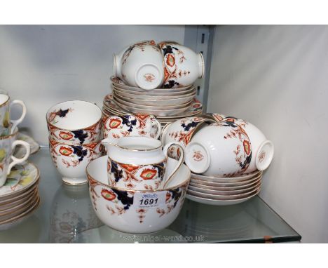 A Tuscan china Teaset including two bread and butter plates, twelve tea plates, cups and saucers, sugar bowl and milk jug