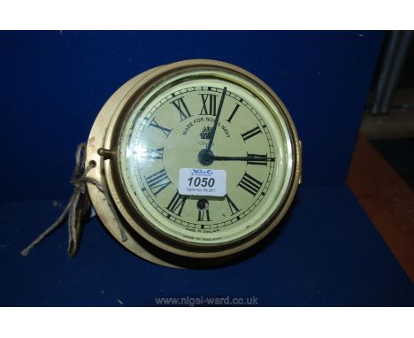A vintage style eight day Brass Ships Clock "as supplied to Royal Navy" with key