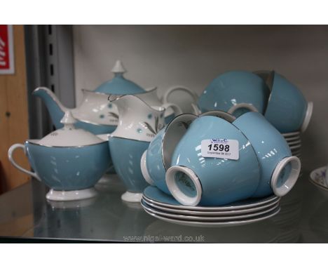 A Royal Doulton 'Caprice' pattern eight setting Teaset including teapot, lidded sugar bowl and milk jug